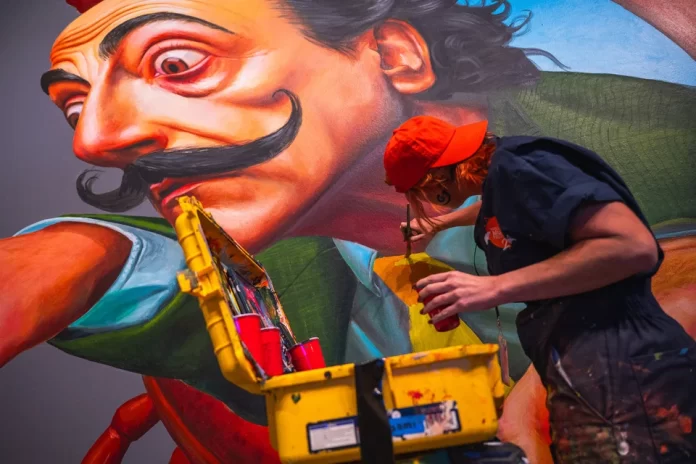Detail of mural artist at work. Photo: James Fashner