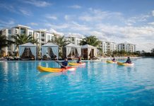 A SHORT DRIVE FROM TAMPA BAY FOR A LUXURY GETAWAY — EVERMORE ORLANDO RESORT Kayaks in front of cabanas