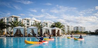 A SHORT DRIVE FROM TAMPA BAY FOR A LUXURY GETAWAY — EVERMORE ORLANDO RESORT Kayaks in front of cabanas