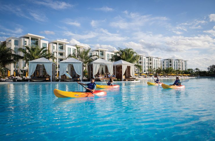 A SHORT DRIVE FROM TAMPA BAY FOR A LUXURY GETAWAY — EVERMORE ORLANDO RESORT Kayaks in front of cabanas