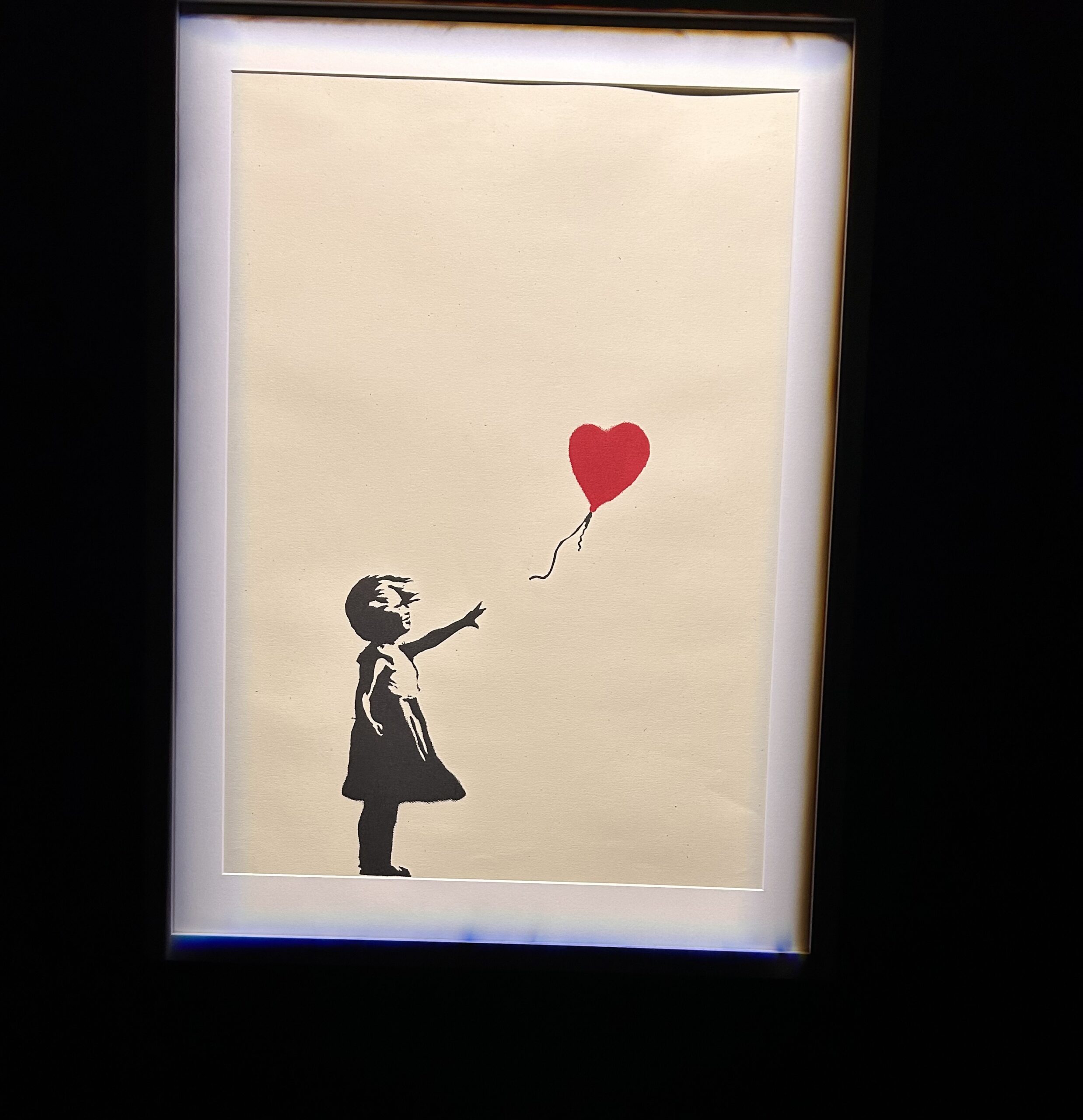Banksy’s Girl with Balloon is an iconic 2002 stencil mural featuring a young girl reaching for a red, heart-shaped balloon.